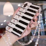 Embellished Piano Keys Phone Case  https://mbell-ish.com/products/embellished-piano-key-phone-case  A stunning phone case and music lover is sure to adore! Compatible Brand: SamsungFeatures: Pearl, Diamond, Black & White Piano Keys, Crystal ChainDesign: Jewelled